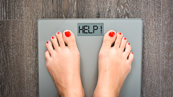 Lose weight concept with person on a scale measuring kilograms