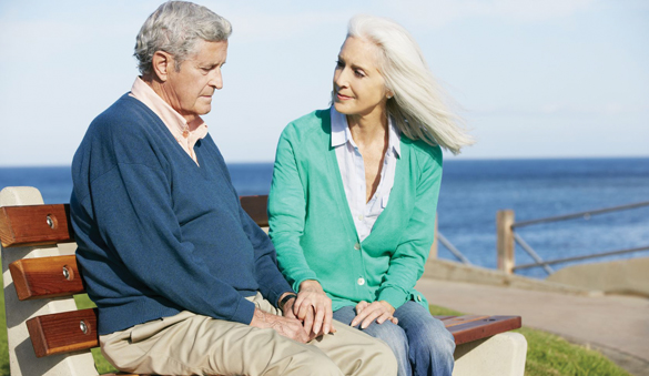 18732519 - senior woman comforting depressed husband sitting on bench