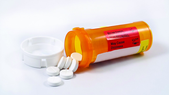 10506792 - pill bottle with white pills on a white background.