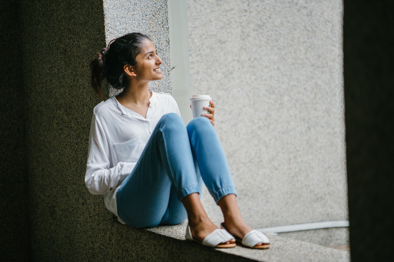 woman-posing-wearing-white-dress-shirt-sitting-on-window-937453