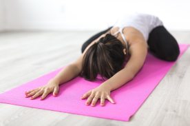 woman-doing-yoga-pose-on-pink-yoga-mat-374589
